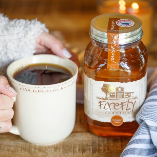 coffee in mug, person's hands, firefly spirits jar