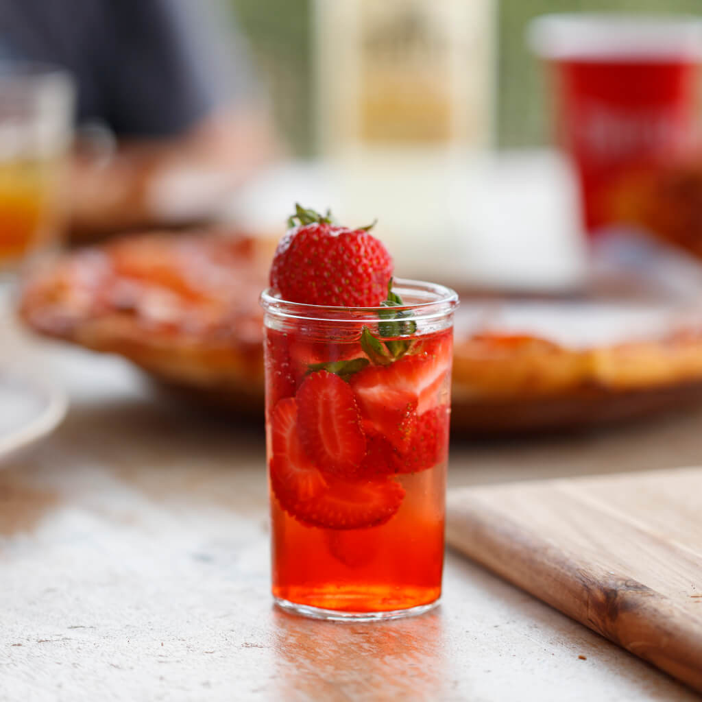 Glass with drink and strawberries