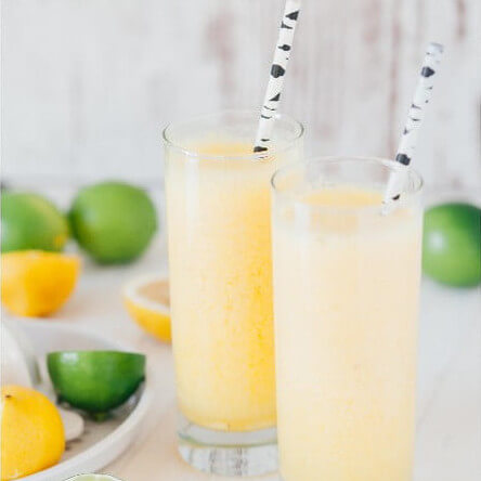 Glasses with lemonade, lime and lemon slices