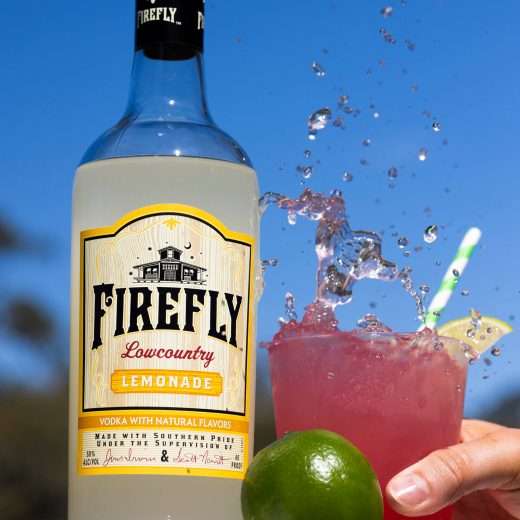 Firefly Lemonade Vodka Bottle, Lime, hand holding beverage in a glass